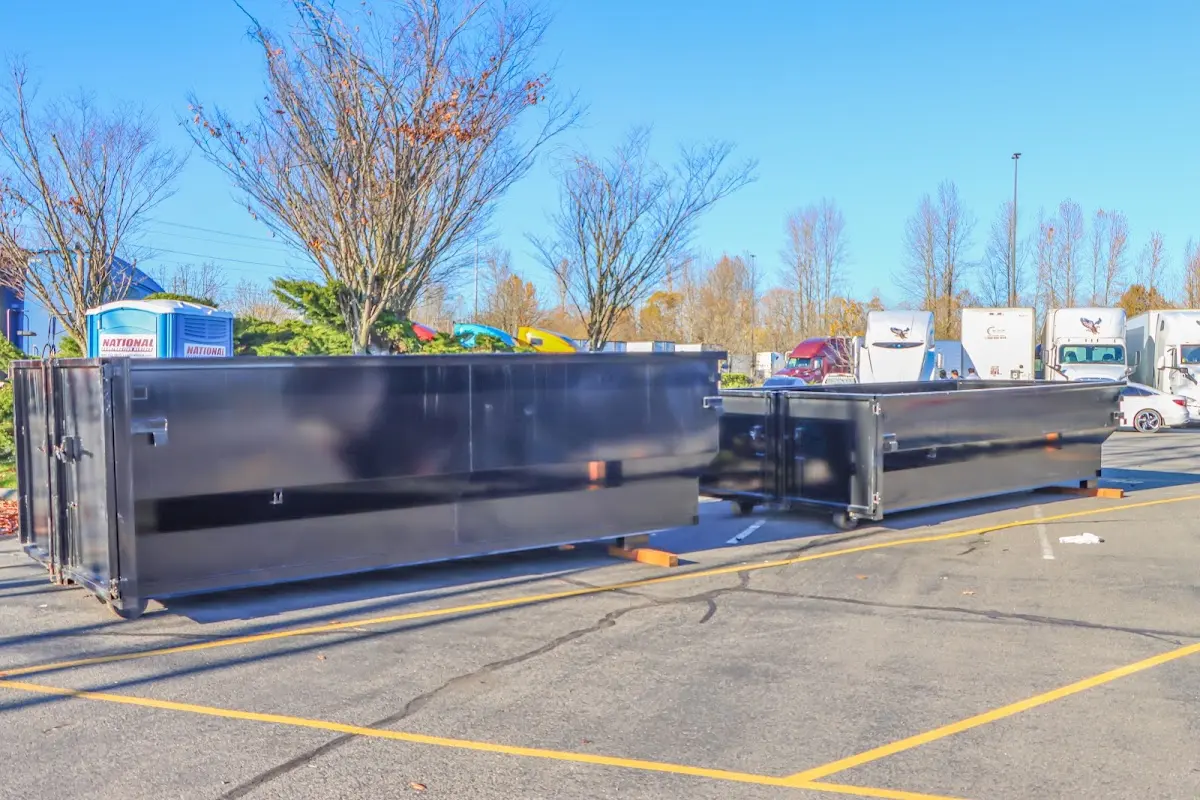 Professional dumpster rental service with roll-off container on residential driveway in San Elizario